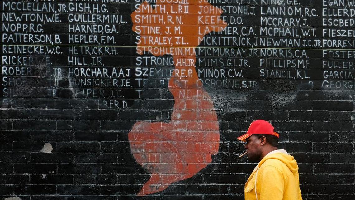 Former Marine Jon Scudder, walks past a vandalized Vietnam War memorial in the Venice area of Los Angeles on Monday. The Los Angeles memorial honoring prisoners and those missing in action during the Vietnam War has had to be covered with tarp on Memorial Day after authorities determined it was too badly damaged by graffiti to be quickly repaired.
