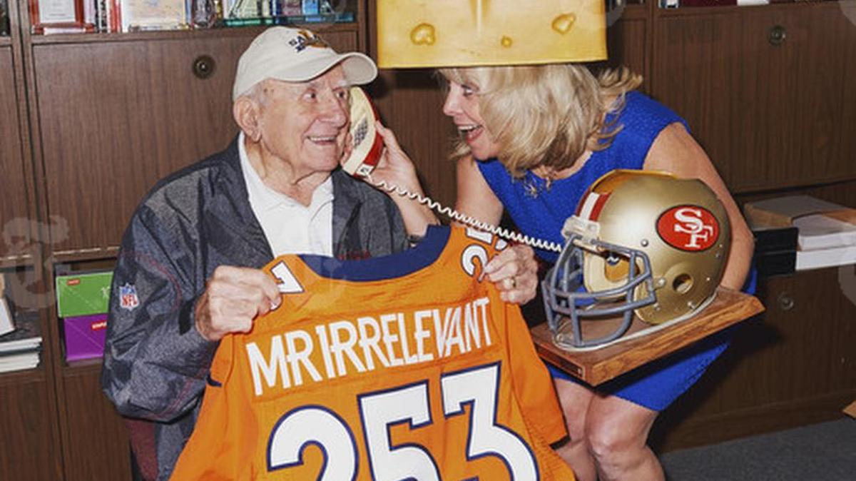 Paul Salata holds a “Mr. Irrelevant” jersey next to his daughter, Melanie Fitch, in Newport Beach, Calif., April 24, 2017. Salata, a 90-year-old former professional football player with a charitable streak and mischievous sense of humor, conceived the moniker, which goes to the last player picked in the NFL draft.