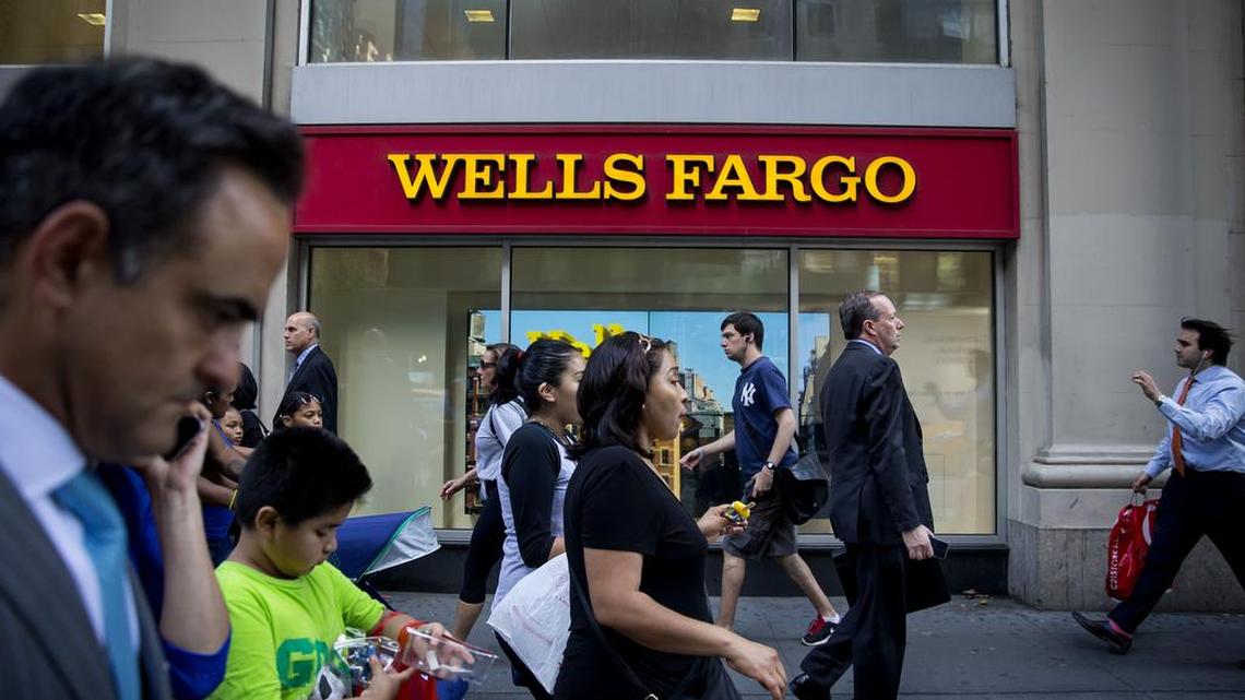 Pedestrians pass in front of a Wells Fargo bank branch in New York on July 12, 2016.