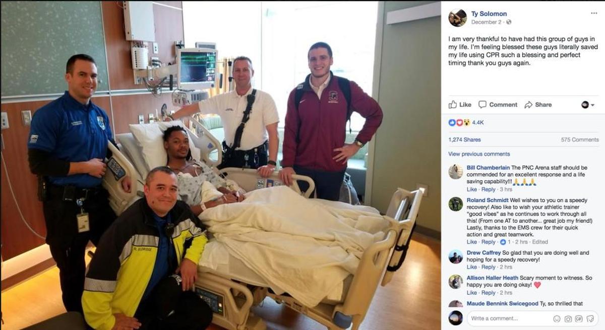 A photo posted to SC State basketball player Ty Solomon’s Facebook page shows him posing for a photo in his hospital room with the four who helped revive him when he collapsed during the game against NC State Saturday.