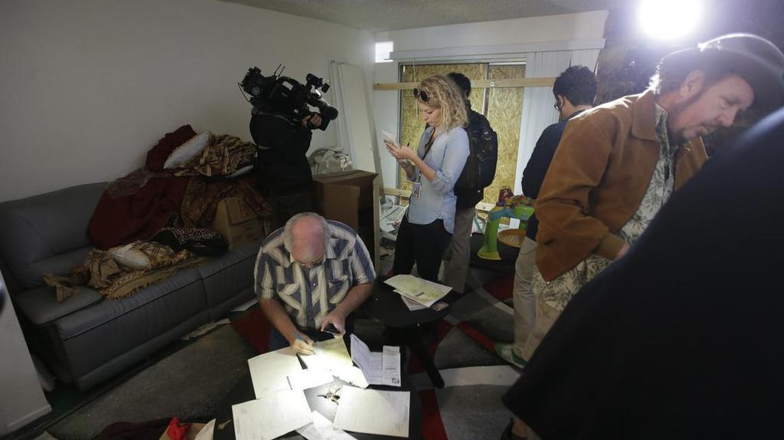 Members of the media crowd into the living room of an apartment in Redlands, California, shared by San Bernardino shooting-rampage suspects Syed Farook and his wife, Tashfeen Malik. The building’s landlord invited them in, but critics saw it as a major lapse in the integrity of the investigation. The FBI defended the presence of the reporters, saying it had finished its examination.