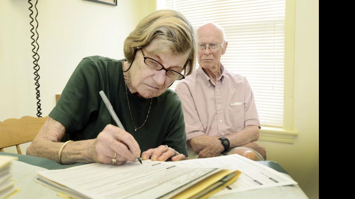 
Janice Ryan signs a living will and health care proxy form with her husband, Richard, in Dundee, N.Y., July 23, 2014. After years of debate about whether the government should encourage end-of-life planning, Medicare, the federal program that insures 55 million older and disabled Americans, is now proposing to reimburse doctors for having conversations with patients about whether and how they would want to be kept alive if they become too sick to speak for themselves. 
