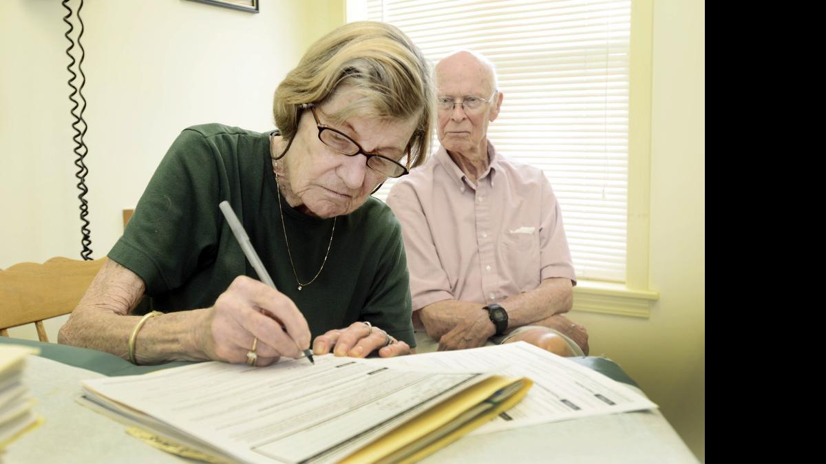 
Janice Ryan signs a living will and health care proxy form with her husband, Richard, in Dundee, N.Y., July 23, 2014. After years of debate about whether the government should encourage end-of-life planning, Medicare, the federal program that insures 55 million older and disabled Americans, is now proposing to reimburse doctors for having conversations with patients about whether and how they would want to be kept alive if they become too sick to speak for themselves. 
