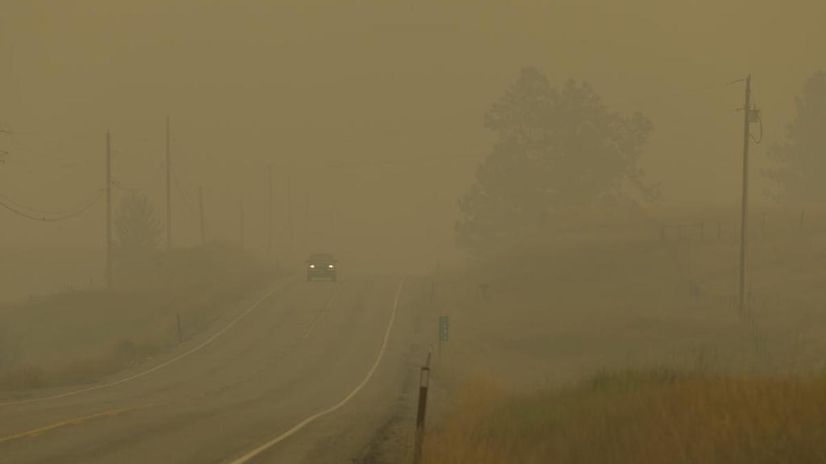 
Thick smoke from nearby wildfires almost obscures State Route 20 between Tonasket, Wash., and Republic, Wash., Wednesday.
