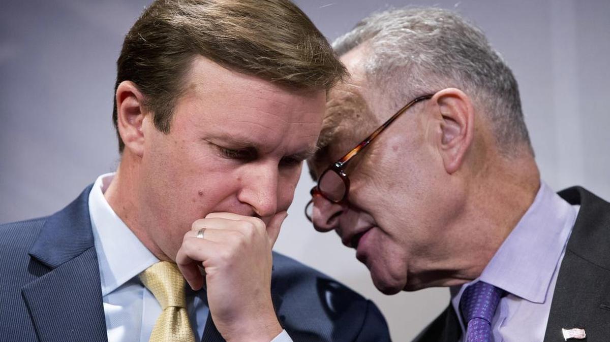 Sen. Charles Schumer, D-N.Y., right, speaks with Sen. Chris Murphy, D-Conn., during a news conference on Capitol Hill in Washington on Dec. 3, 2015 to discuss gun control.