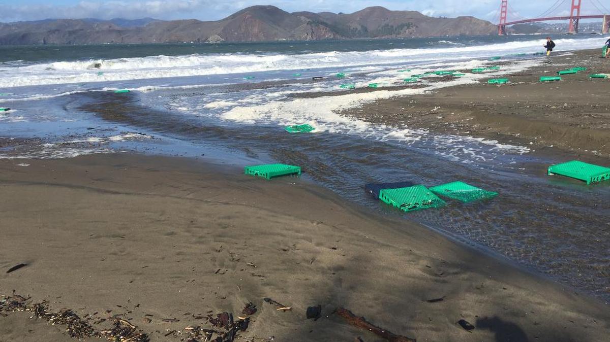 Debris from plastic pallets from a lost shipping container washes ashore in San Francisco’s Baker Beach on Sunday. The U.S. Coast Guard says 12 containers, most of them empty, were washed overboard of a cargo ship just outside the Golden Gate Bridge on Friday by stormy seas.