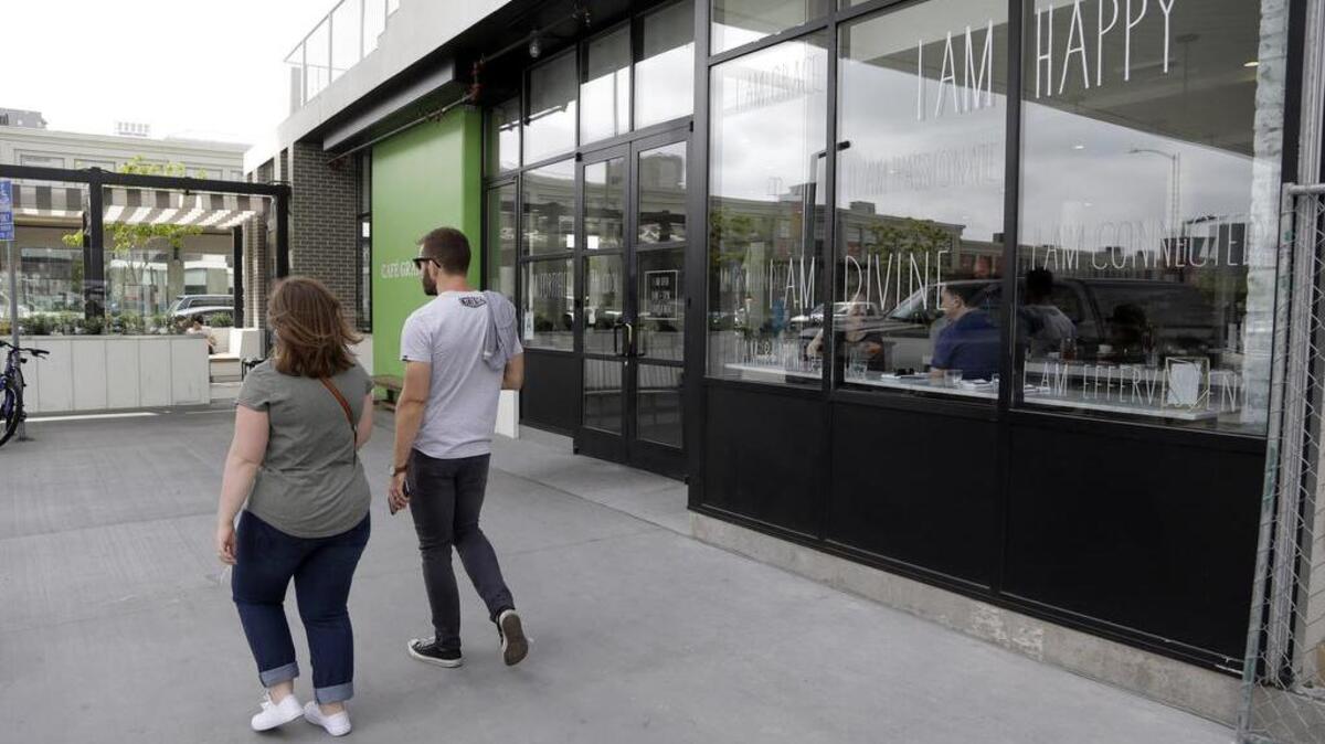 This Wednesday, May 4, 2016 photo shows Cafe Gratitude restaurant in Los Angeles. At the Cafe Gratitude restaurant chain in California, waiters serve plates of vegan rice bowls, vegetable pizzas and tempeh sandwiches with names like "Gracious," ''Warm-Hearted" and "Magical." Angry patrons and animal rights activists are calling on vegans to boycott the restaurant after learning that owners Matthew and Terces Engelhart have begun eating meat and consuming animals raised on their private farm.