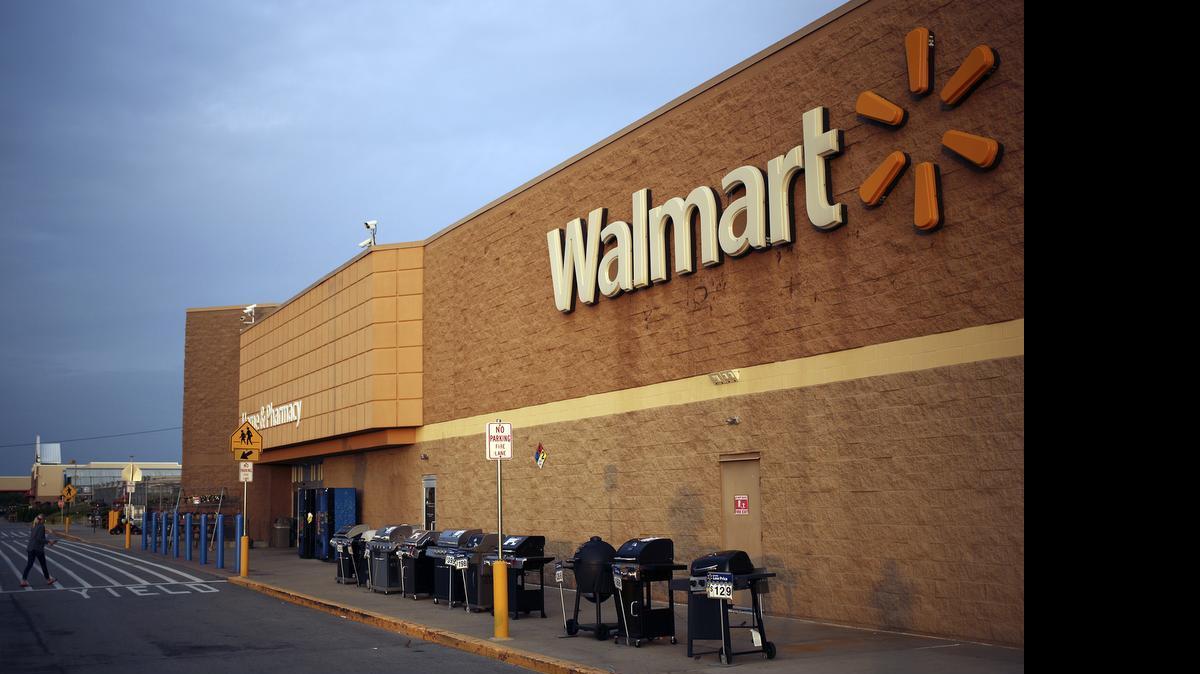 
Wal-Mart Stores Inc. is doubling down on its efforts to get customers to rethink the way they shop for groceries, blending the in-store and online experience. Here, gas grills are displayed for sale outside a Walmart in Shelbyville, Kentucky, on May 18, 2015. 
