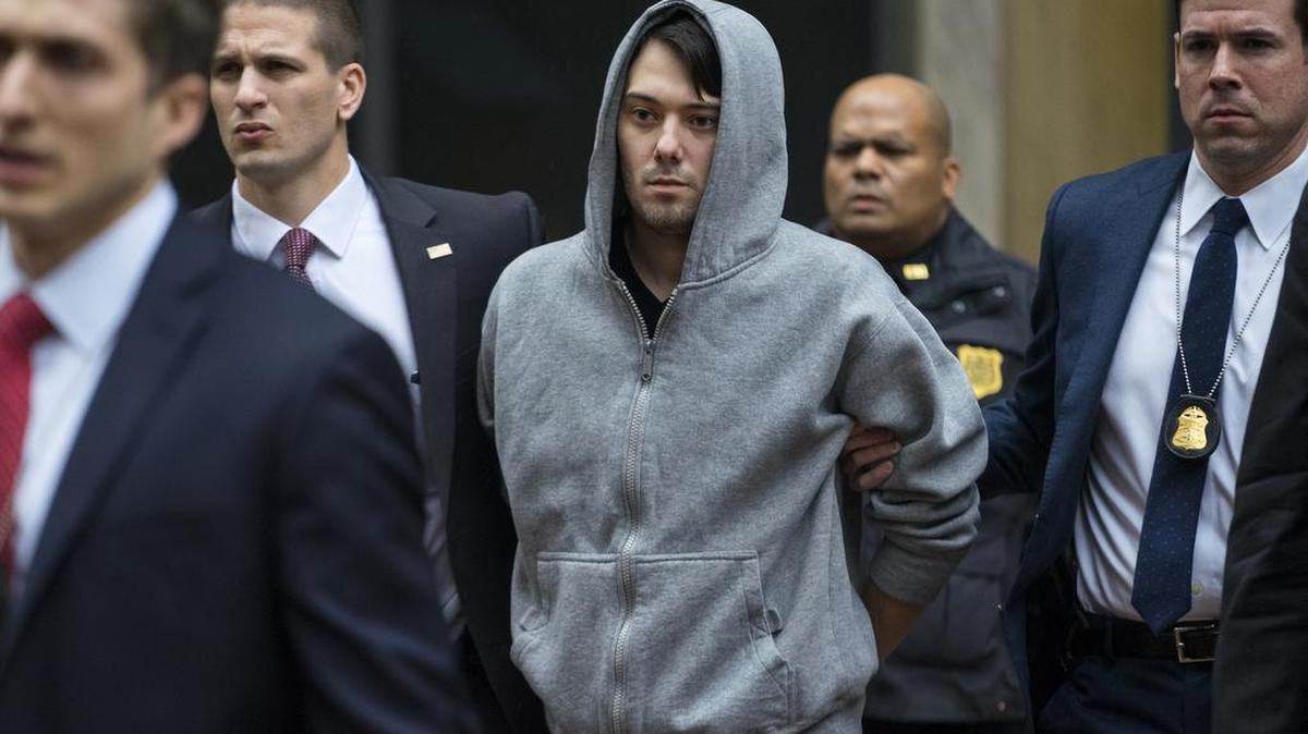 In this Dec. 17, 2015 file photo, Martin Shkreli, the former hedge fund manager under fire for buying a pharmaceutical company and ratcheting up the price of a life-saving drug, is escorted by law enforcement agents in New York after being taken into custody following a securities probe.