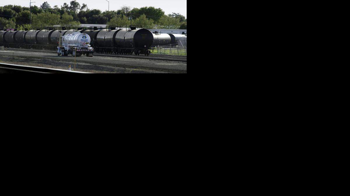 
Recently filled, a tanker truck drives past railway cars containing crude oil on railroad tracks in McClellan Park in North Highlands on Wednesday, March 19, 2014. North Highlands is a suburb of Sacramento, Calif.
