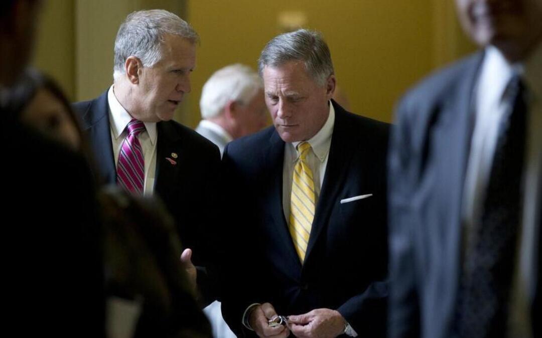 Sen. Thom Tillis, R-N.C., left, and Sen. Richard Burr, R-N.C., walk from a policy luncheon on Capitol Hill in Washington in 2015.