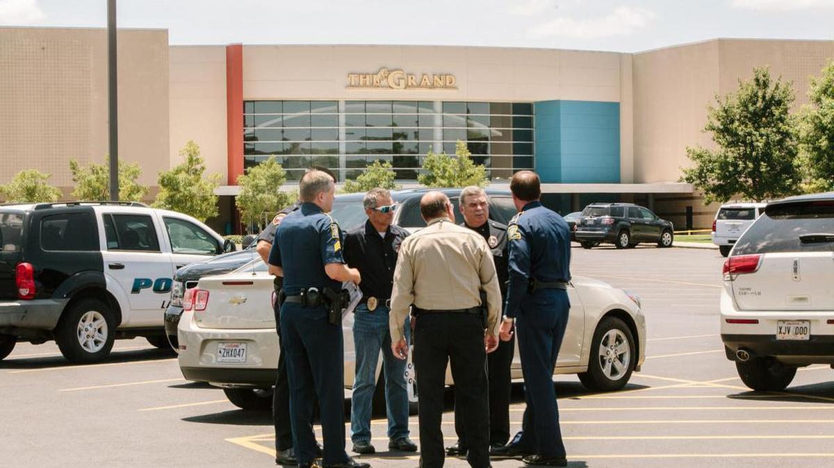 Law enforcement officials speak outside the Grand Theater on July 24 the day after a gunman killed two moviegoers and wounded nine more before taking his own life, in Lafayette, La. Shooter John R. Houser left a rambling, hate-filled journal in which he called the U.S. a “filth farm,” railed against women, gays and blacks, and thanked a man accused of killing nine churchgoers in South Carolina for his “wake up call.”