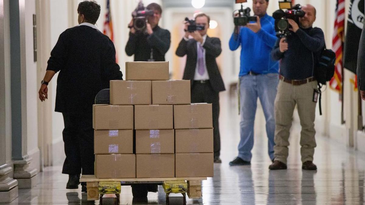 A staff member delivers President Barack Obama's fiscal 2017 federal budget to the House Budget Committee Room on Capitol Hill in Washington, Tuesday, Feb. 9, 2016. President Barack Obama unveils his eighth and final budget, a $4 trillion-plus proposal that’s freighted with liberal policy initiatives and new and familiar tax hikes, sent to a dismissive Republican-controlled Congress.