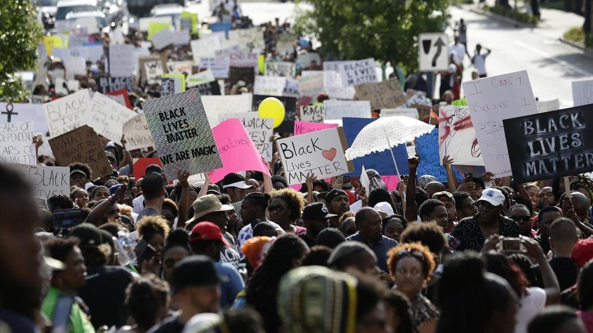 Demonstrators march through downtown Atlanta to protest the shootings of two black men by police officers, Friday, July 8, 2016. Thousands of people marched along the streets of downtown to protest the recent police shootings of African-Americans.