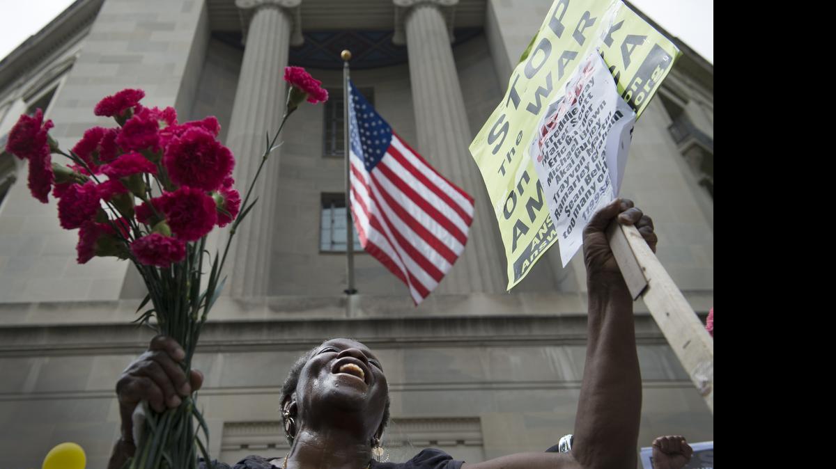 
Dorothy Copp Elliott from Prince George's County, Md., rallies in support of mothers in the “Million Mom March” in front the the Department of Justice in Washington on Saturday, May 9, 2015. More than a dozen mothers from around the country whose sons or daughters had been killed by police, or while in police custody, were joined by several hundred protesters to demand sweeping police reforms. 
