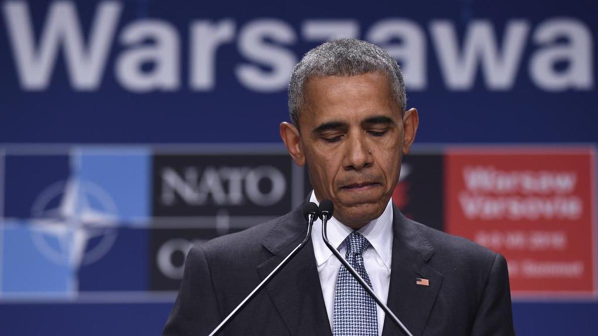 President Barack Obama pauses while speaking about the events in Dallas at the beginning of his news conference at PGE National Stadium in Warsaw, Poland, July 9, 2016. Obama was in Warsaw attending the NATO Summit.