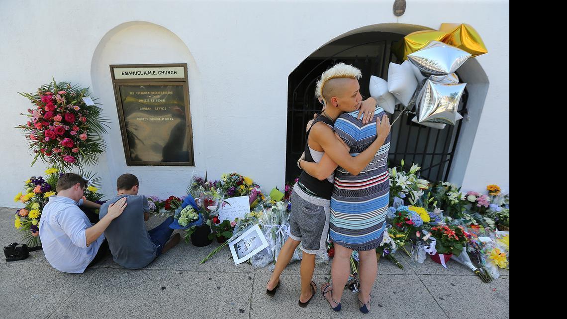 
From left, Alston Rich, Brad Hutchinson, Ashley Edge and Elizabeth Elliott comfort each other Thursday at the memorial in front of the Emanuel AME Church where nine people were killed including the pastor on Wednesday in Charleston, S.C.
