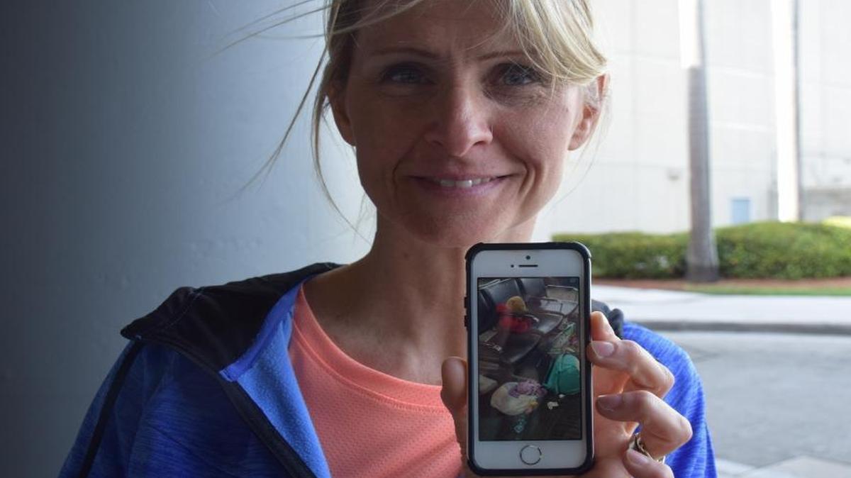 Kim Lariviere, a Canadian teacher, holds up a photo of Rufus, a teddy bear her late father gave her daughter before he died. Rufus and other carry-on items were lost during the frenzy that ensued after a gunman opened fire at Fort Lauderdale-Hollywood International Airport Friday afternoon.