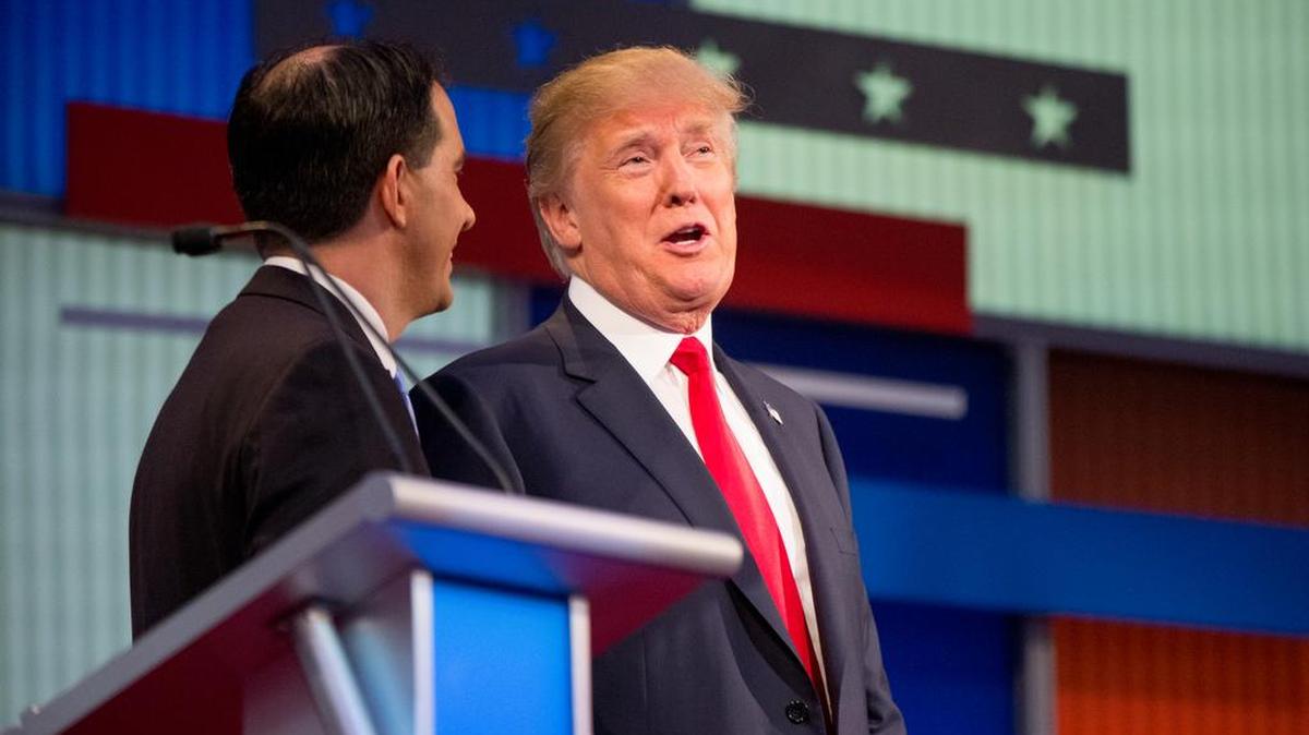 
Republican presidential candidates Wisconsin Gov. Scott Walker, left, and Donald Trump, converse during a commercial break while participating in the first Republican presidential debate at the Quicken Loans Arena, Thursday, Aug. 6, 2015, in Cleveland. 
