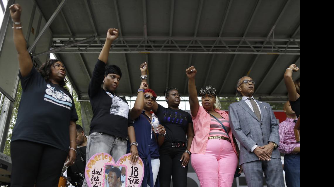 
The Rev. Al Sharpton, right, is joined on stage by shooting victim Oscar Grant’s mother, Wanda Johnson, left; shooting victim Ramarley Graham’s mother, Constance Malcolm, second from left; shooting victim Michael Brown’s mother, Leslie McSpadden, third from left; shooting victim Trayvon Martin’s mother, Sybrina Fulton, third from right; and shooting victim Eric Garner’s mother, Gwen Carr, during a rally in New York on Saturday, July 18, 2015. Several hundred people rallied outside the federal courthouse in Brooklyn to demand action in the fatal chokehold death of Eric Garner by a white police officer. 
