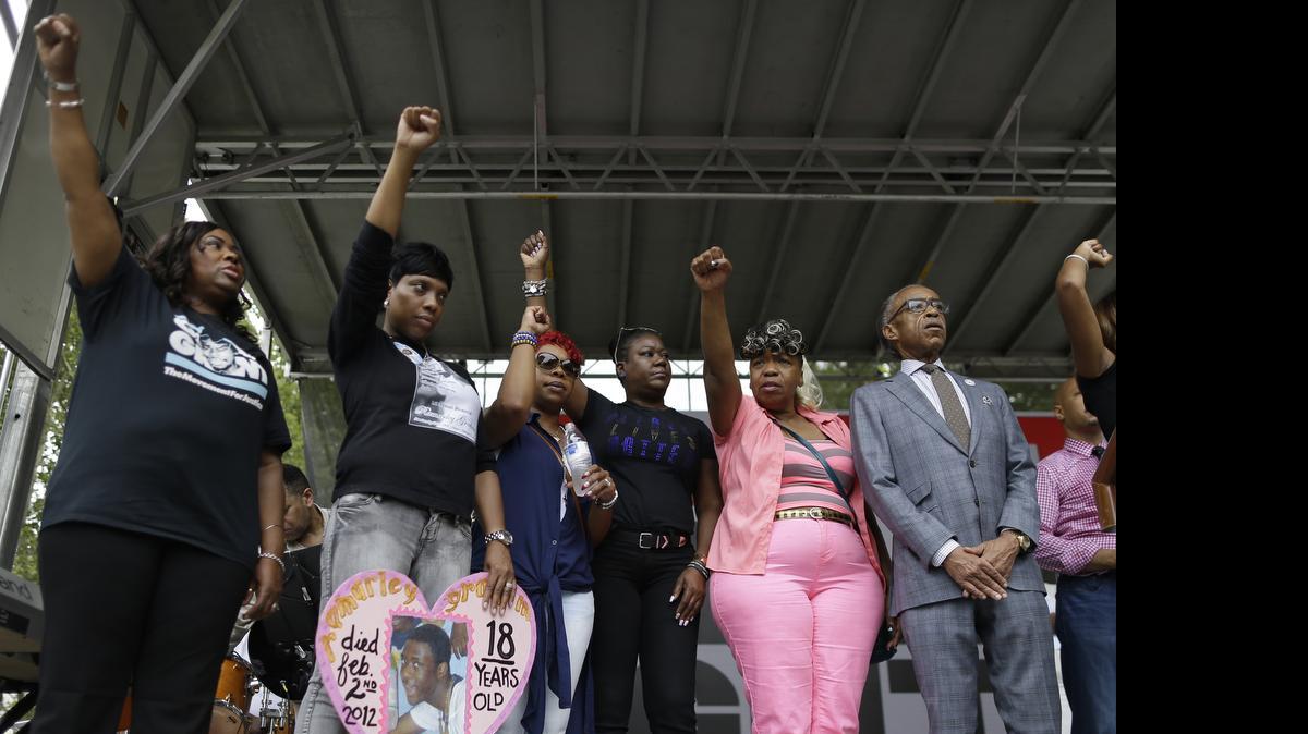 
The Rev. Al Sharpton, right, is joined on stage by shooting victim Oscar Grant’s mother, Wanda Johnson, left; shooting victim Ramarley Graham’s mother, Constance Malcolm, second from left; shooting victim Michael Brown’s mother, Leslie McSpadden, third from left; shooting victim Trayvon Martin’s mother, Sybrina Fulton, third from right; and shooting victim Eric Garner’s mother, Gwen Carr, during a rally in New York on Saturday, July 18, 2015. Several hundred people rallied outside the federal courthouse in Brooklyn to demand action in the fatal chokehold death of Eric Garner by a white police officer. 
