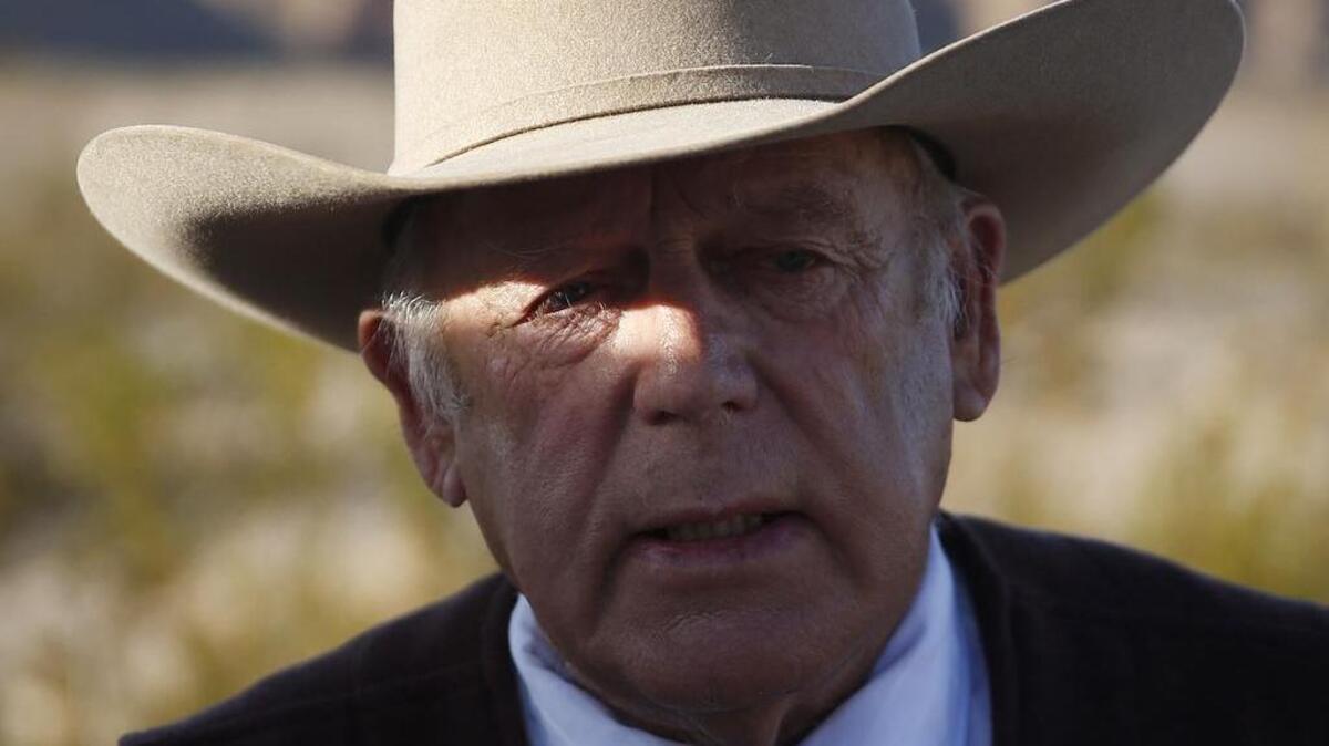 Rancher Cliven Bundy speaks to media while standing along the road near his ranch Wednesday, Jan. 27, 2016, in Bunkerville, Nev.
