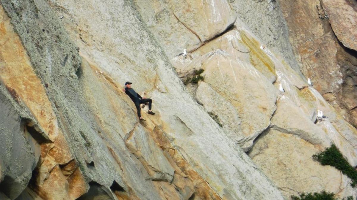 Michael John Paul Banks, 27, of Fresno waiting to be rescued from Morro Rock on Thursday. Banks climbed the rock to propose to his girlfriend by Facetime mobile app, authorities said. He has since been arrested on possible drug charges.