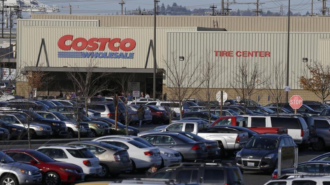 Cars fill the parking lot of a Costco store, Nov. 24, 2015, in Seattle.