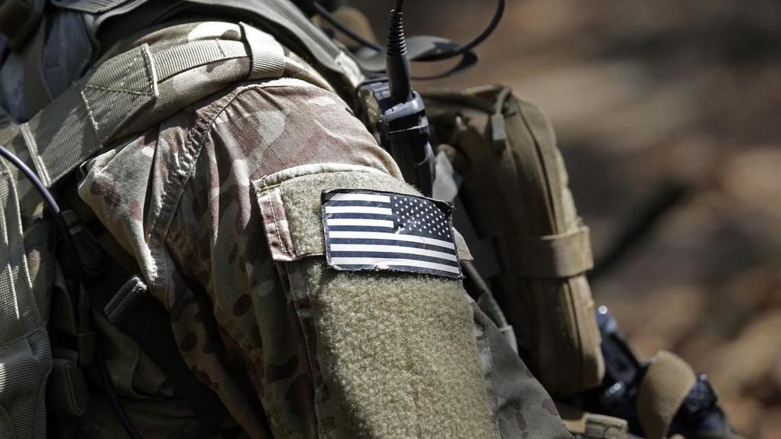 In this photo taken Friday, April 21, 2017, a United States flag patch adorns the uniform of a paratrooper with the 82nd Airborne Division’s 3rd Brigade Combat Team during a training exercise at Fort Bragg, N.C. The Army is planning to triple the amount of bonuses it’s paying this year to more than $380 million in a bid to expand its ranks.