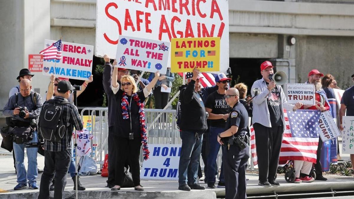 Police stand by as demonstrators who support President Donald Trump's executive orders barring entry to the U.S. by travelers from seven Muslim-majority countries demonstrate near Los Angeles International Airport.