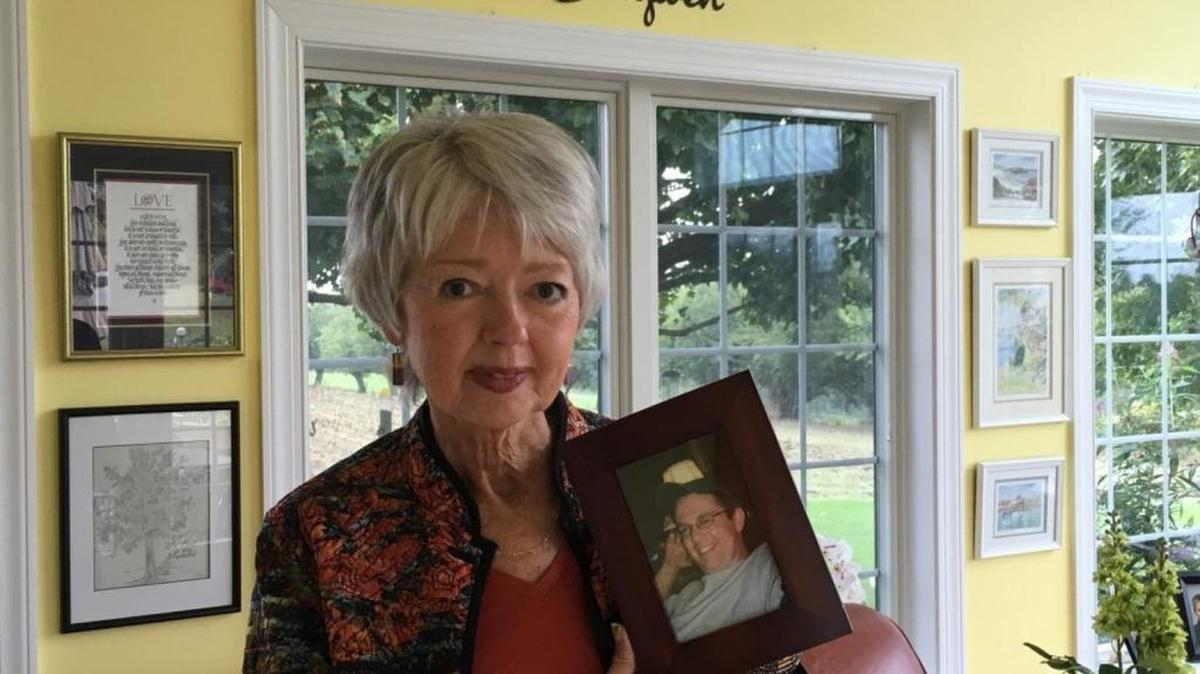 Terri Roberts holds a photo of her son, Charles Carl Roberts IV, who shot and killed Amish girls in their schoolhouse 10 years ago.