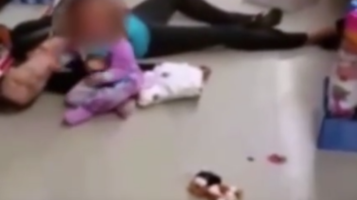 A video, reportedly taken by a store employee, shows a 2-year-old girl desperately trying to wake up her mother, who has apparently collapsed due to a heroin overdose.