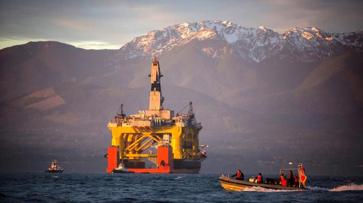 
A small boat crosses in front of the Transocean Polar Pioneer, a semi-submersible drilling unit that Royal Dutch Shell leases from Transocean Ltd., as it arrives in Port Angeles, Wash. aboard a transport ship after traveling across the Pacific before its eventual Arctic destination. The Interior Department announced Friday it is canceling future lease sales and will not extended current leases in Arctic waters off Alaska's northern coast, a decision that significantly reduces the chances for future Arctic offshore drilling.
