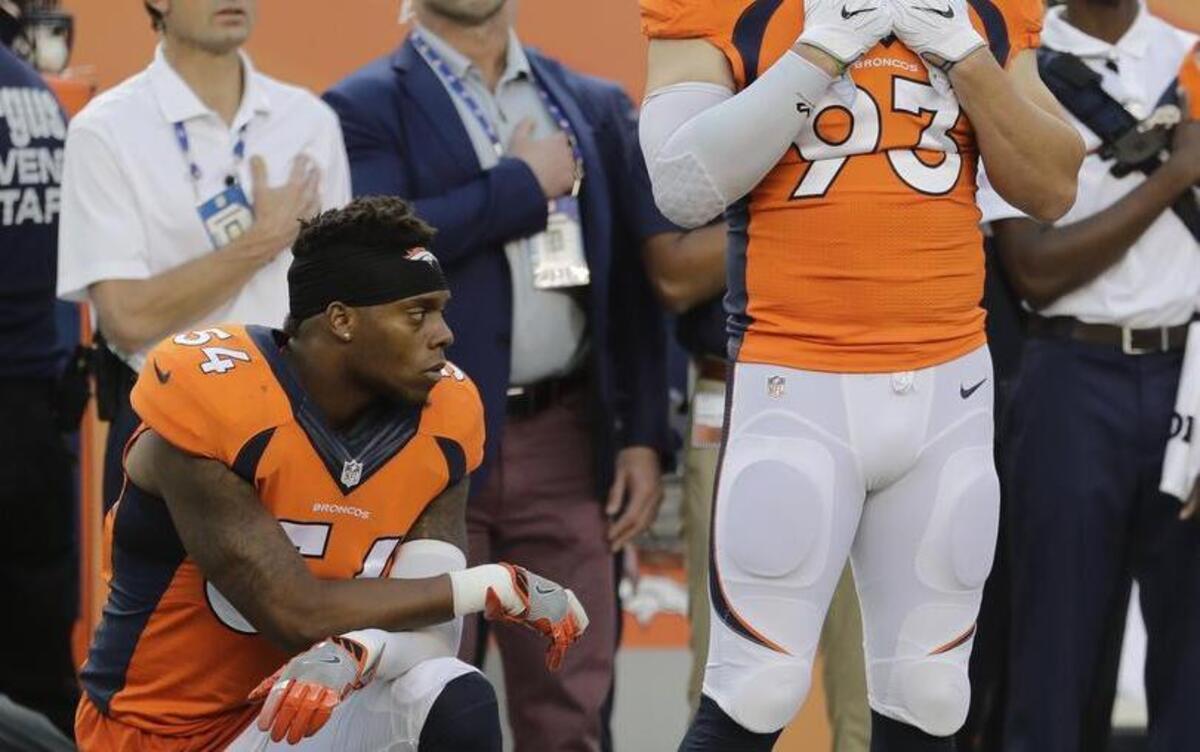 Denver Broncos inside linebacker Brandon Marshall (54) kneels on the sideline during the national anthem before an NFL football game Sept. 8 against the Carolina Panthers in Denver.