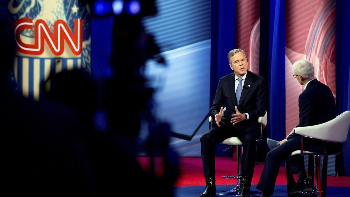 Republican presidential candidate former Florida Gov. Jeb Bush, accompanied by Anderson Cooper, right, speaks at a CNN town hall Thursday at the University of South Carolina in Columbia, S.C.