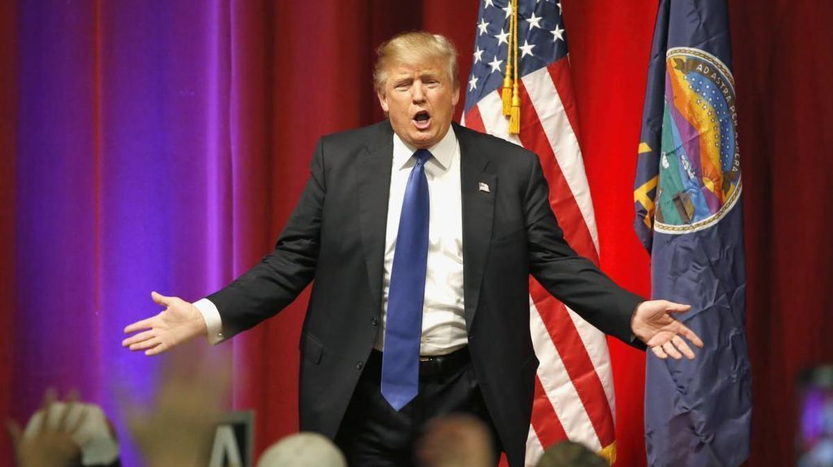 Republican presidential candidate Donald Trump encourages his supporters to go caucus after a campaign rally, Saturday, March 5, 2016, in Wichita, Kan.