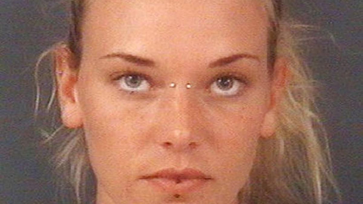 In this undated photo released by the Cumberland County Sheriff's Office, in Fayetteville, N.C., Marinna Rollins, poses for a photo. Rollins was arrested Tuesday, April 25, 2017, and charged with cruelty to animals. The veteran has been charged with tying her service dog to a tree and shooting it five times while a soldier filmed it.