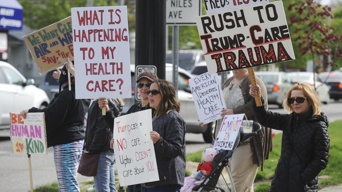 People gather outside of Rep. Fred Upton’s St. Joseph, Mich., office Wednesday, May 3, 2017, to protest his support of the health care bill. Upton and Billy Long of Missouri emerged from a White House meeting with President Donald Trump saying they could now support the propose health care bill, thanks to the addition of $8 billion over five years to help people with pre-existing conditions.