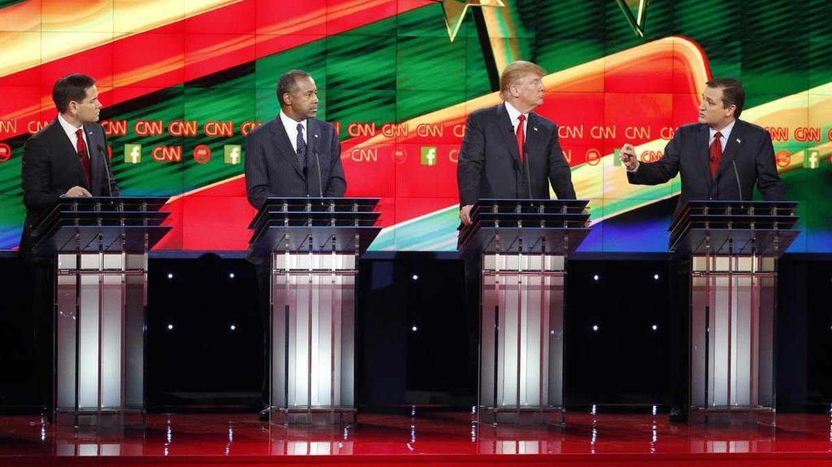 Ted Cruz, right, speaks during an exchange with Marco Rubio, left, as Ben Carson, second from left, and Donald Trump look on during the CNN Republican presidential debate at the Venetian Hotel & Casino on Tuesday, Dec. 15, 2015, in Las Vegas.