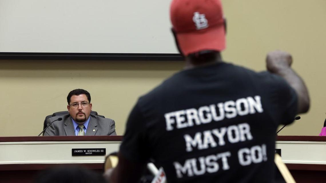 
Phil Gassoway, right, speaks as Ferguson mayor James Knowles III listens during a City Council July 28, 2015, meeting in Ferguson, Mo. The mayor has acknowledged that events after Brown's death exposed fissures that had long existed in the community, and though there have been changes, for many the change hasn't gone far enough.

