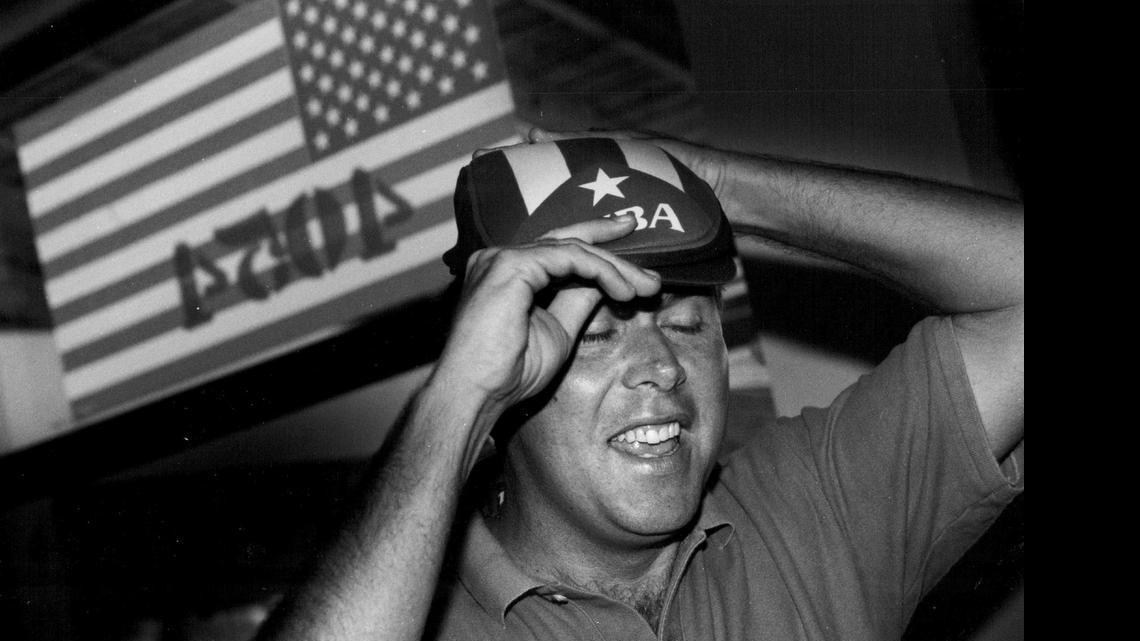 
Jeb Bush tries on a Cuban hat given to him by Pedro Garcia just before going through some Hialeah neighborhoods to canvas votes for his dad George Bush on Oct. 25, 1992.
