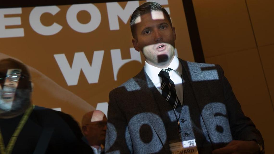 Richard Spencer, president of the National Policy Institute, answers questions from the media at the annual white nationalist conference hosted by his organization at the Ronald Reagan Building in Washington.