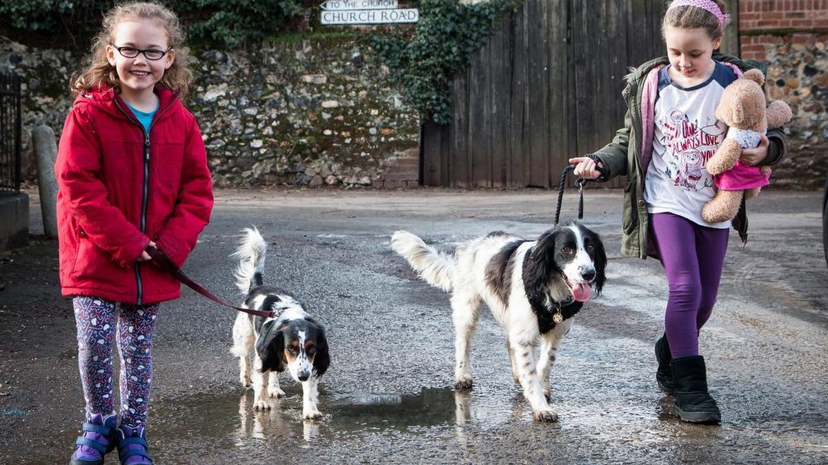 Two girls walk dogs Beanie and Jelly Bean in Bildeston, England.