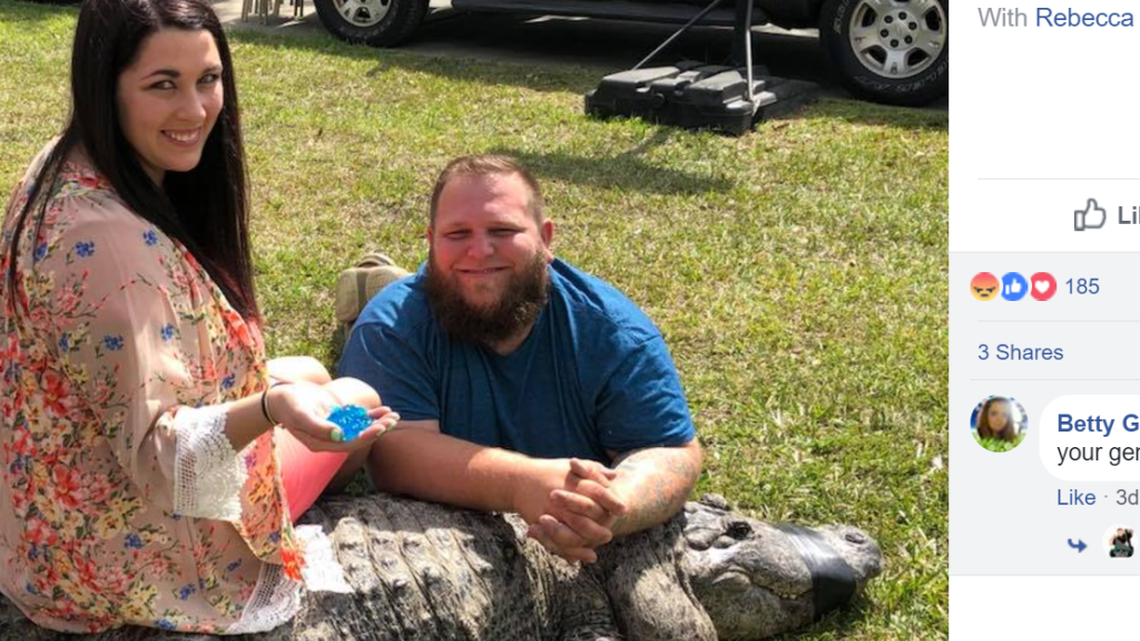 Mike Kliebert and Rebecca Miller with Sally, the alligator, after their gender reveal party.