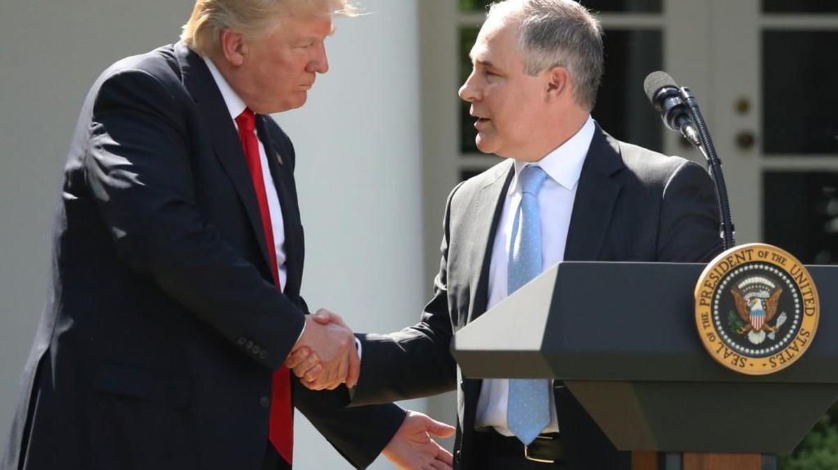 In this June 1, 2017 file photo, President Donald Trump shakes hands with EPA Administrator Scott Pruitt after speaking about the U.S. role in the Paris climate change accord in the Rose Garden of the White House in Washington.
