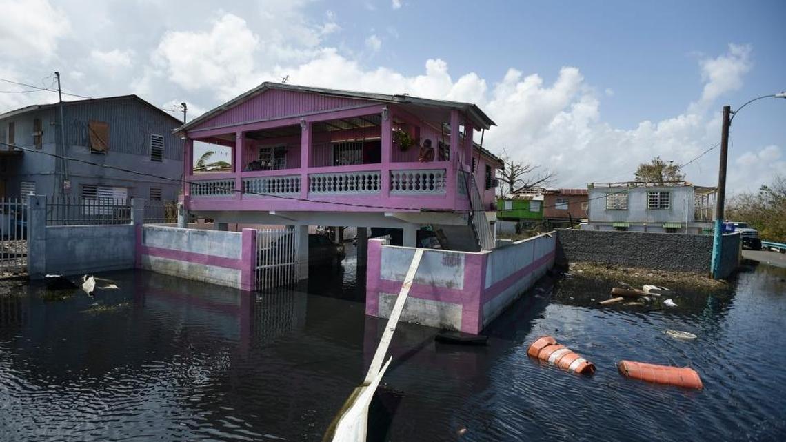 Homes in the Juana Matos community are surrounded by flood waters in Catano, Puerto Rico, one week after Hurricane Maria came through. Few in the territory were covered by flood insurance.