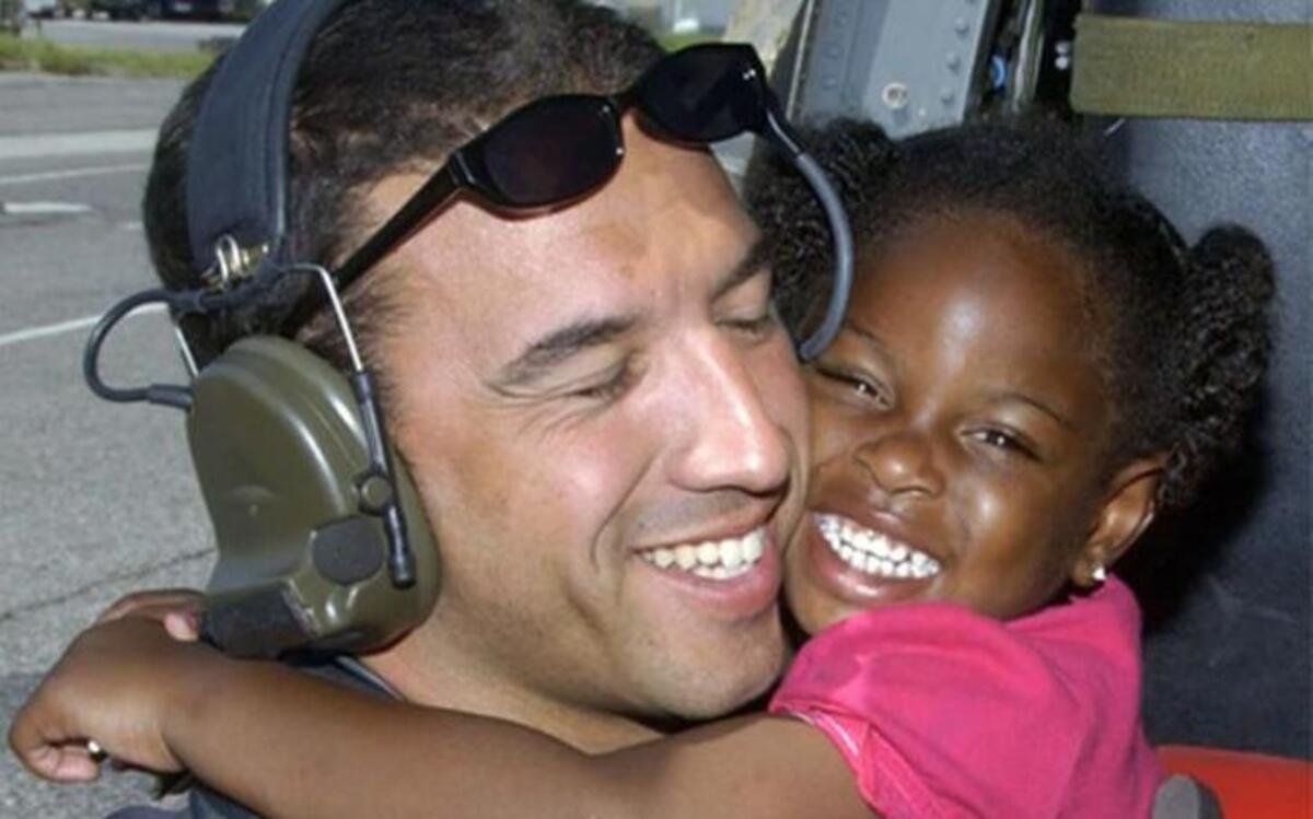 
Then-Staff Sgt. Michael Maroney gets a hug from a survivor of Hurricane Katrina in New Orleans on Sept. 7, 2005. Maroney was an Air Force pararescue jumper who helped rescue people after the hurricane.
