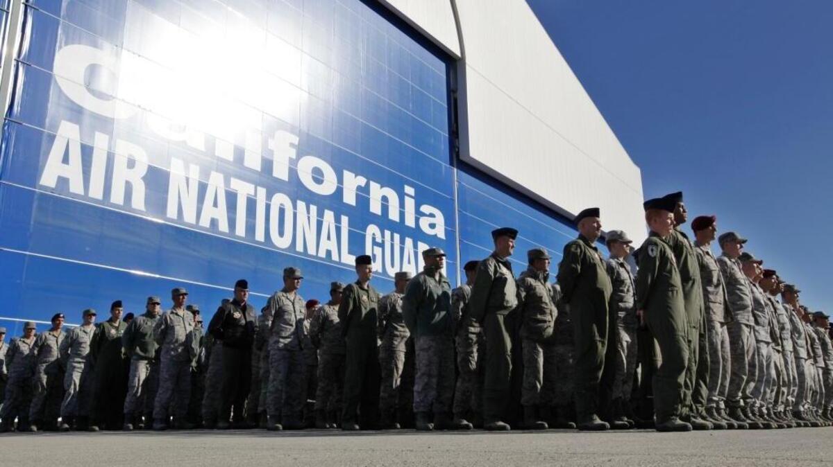 FILE - In this Nov. 30, 2011 file photo, California Army National Guard soldiers watch the arrival of the body of soldier Sean Walsh, who died on Nov. 16 during a combat operation in Afghanistan, at Moffett Federal Airfield in Mountain View, Calif. (AP Photo/Paul Sakuma, File)