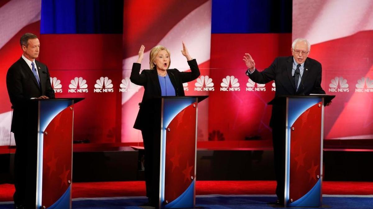Sen. Bernie Sanders answers a question as Hillary Clinton gestures during the NBC-YouTube Democratic presidential debate at the Gaillard Center on Sunday, Jan. 17, 2016, in Charleston, S.C. Former Maryland Gov. Martin O’Malley is at left.