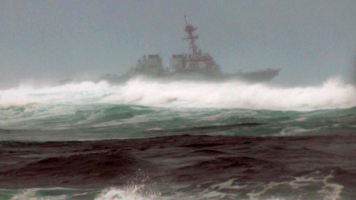 A search vessel cruises the waters off the beach at Haleiwa, Hawaii, Friday, Jan. 15, 2016. Two Marine helicopters carrying 12 crew members collided off the island of Oahu during a nighttime training mission, and rescuers are searching a debris field in choppy waters, military officials said.